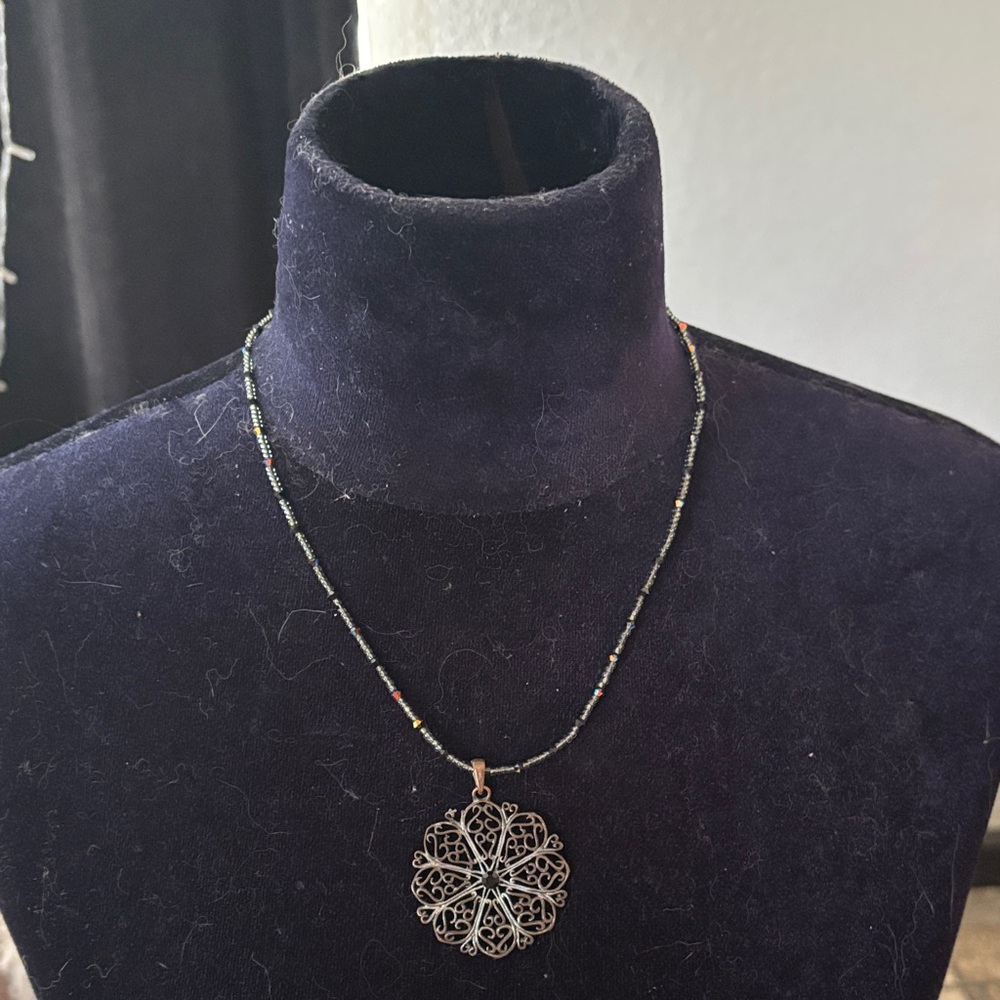 Filagree Pendant Ornate Flower Suspended From A Beaded Chain